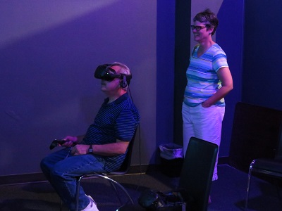 Lisa watches as hubby tries out the Virtual Reality lab